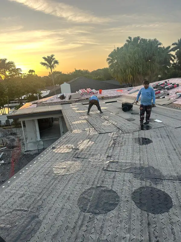 Workers preparing the roof for the job